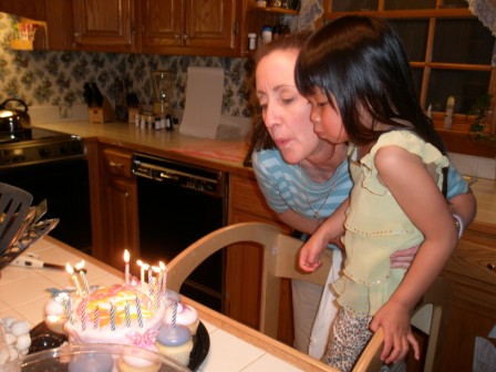 Kasen helping Mommy blow out the candles